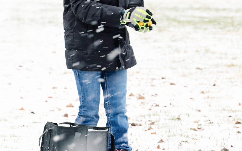 Braving blowing snow and chilly temperatures, Alexis Roesler joined fellow Jerauld-Buffalo 4-H members in hiding eggs ahead of the Wessington Springs Community Easter Egg Hunt.