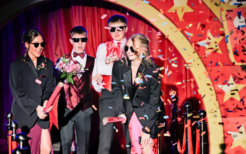 The second time around, students let loose, complete with confetti, coordinated moves and plenty of laughter during Grand March. Shown at left are freshmen Kenzie Kolousek, Sutten Jensen, Cole Wenzel and Lily Roesler.