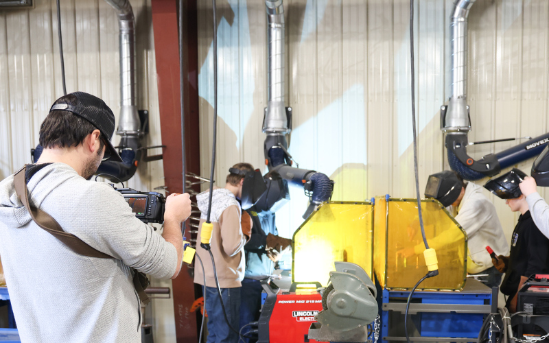 Filmmaker Zeke Hanson captures footage of students welding inside the recently renovated vo-ag shop at Wessington Springs High School as part of a documentary on 100 years of FFA in South Dakota. (KRISTI HINE / TRUE DAKOTAN)