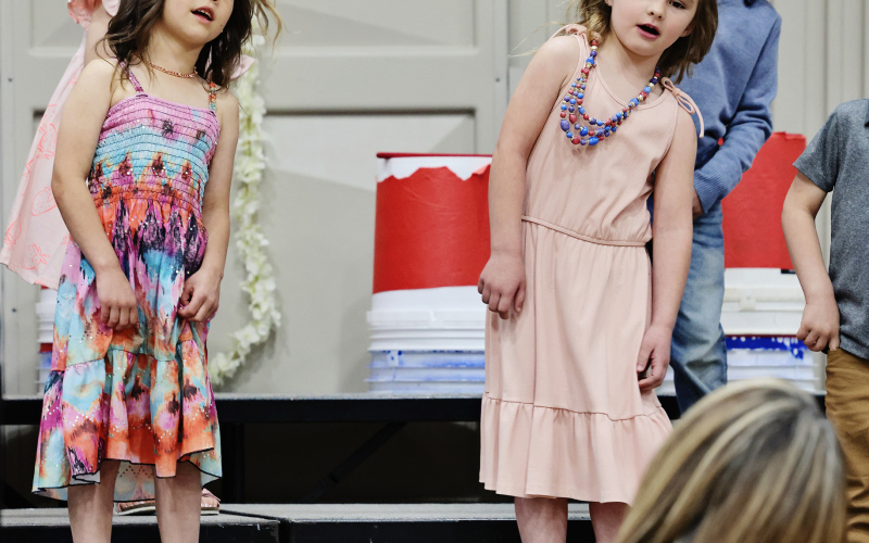 Director Julie Fastnacht leads the preschool class in a performance of “Humpty Dumpty” during the Wessington Springs Elementary Spring Concert May 4, 2026. Moxee Mitchell and Hailey Hasty are pictured on stage. (KRISTI HINE / TRUE DAKOTAN)