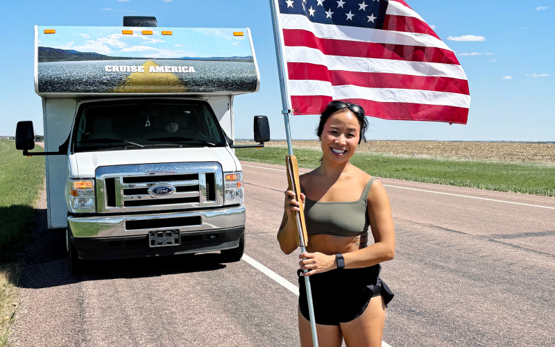 Mai Richards poses in front of the camper accompanying her across South Dakota during her 25-day “Miles of Honor” run benefiting veteran organizations. Richards is traveling from Sioux Falls to Sturgis while carrying the American flag in honor of fallen service members.