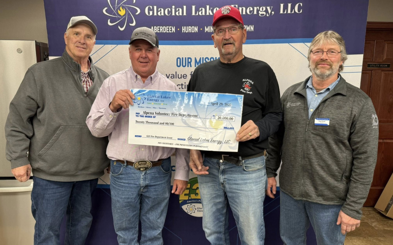 Presenting the Glacial Lakes Energy Fire Department Grant check are GLE Board of Directors representatives Mark Schmidt, Noel Pond, and Brent Gabler. Accepting the check on behalf of the Alpena Fire Department is Gary Orth.