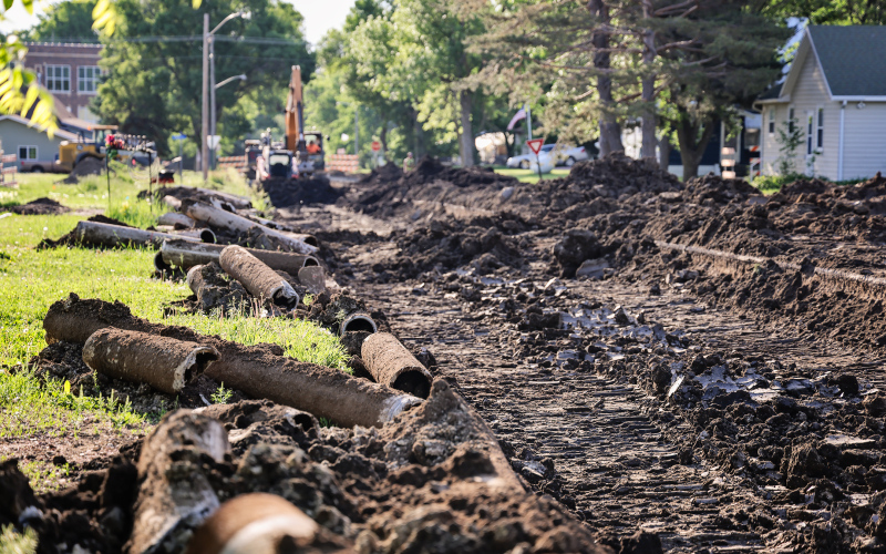Old cast iron water mains removed from beneath 2nd Street sit alongside an active construction zone as crews continue work on Wessington Springs' water main replacement project. (KRISTI HINE / TRUE DAKOTAN)