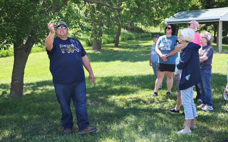 Wessington Springs High School Vo-Ag instructor Brady Duxbury points out identifying characteristics of trees during “A Walk in the Park” on May 31 in Wessington Springs City Park.