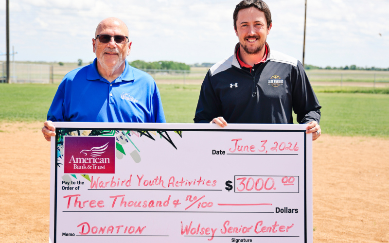 Wolsey Senior Center board member Dave Burnison, left, presents a $3,000 donation to Riley Donovan to support the Wolsey Summer Recreation baseball program. The contribution helped expand the program to include both tee ball for ages 4-5 and coach-pitch baseball for ages 6-7. Nearly 40 youth are participating this summer, with games scheduled Mondays and Wednesdays throughout June. (KRISTI HINE / TRUE DAKOTAN)