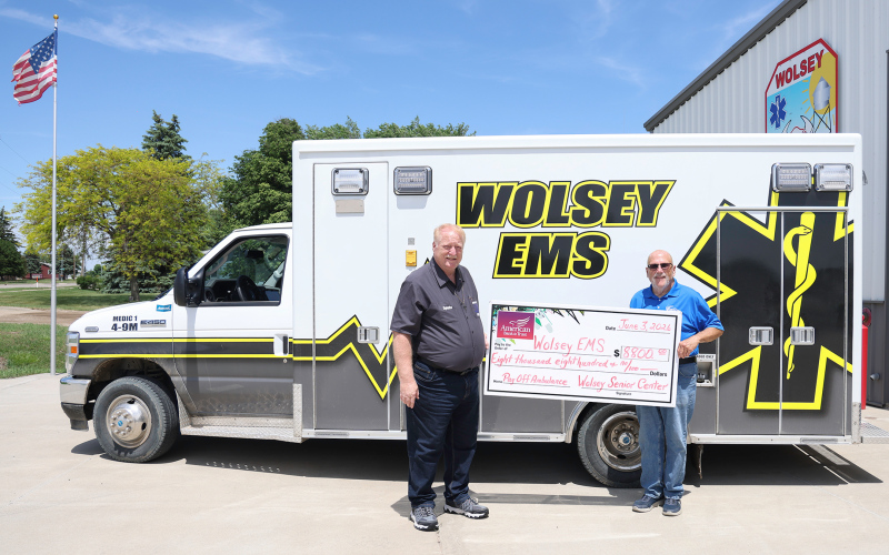 Wolsey Senior Citizen Center Incorporated board member Dave Burnison, right, presents an $8,800 check to Wolsey EMS Director Scott Spiehs at the Wolsey Fire Hall. The donation retired the remaining balance on the community’s ambulance, helping pay off approximately $170,000 in debt in just two years through community fundraising efforts, donations and grants. (KRISTI HINE/TRUE DAKOTAN)