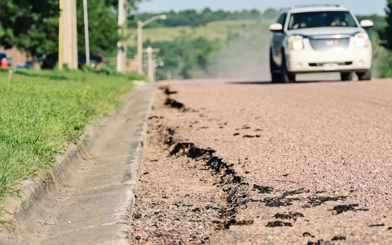 Washouts are visible along the curb and gutter on the recently installed surface of Second Street north of Our Savior's Lutheran Church. City officials have declined to accept substantial completion of the project while awaiting a repair plan from H&amp;W Contracting. (KRISTI HINE / TRUE DAKOTAN)