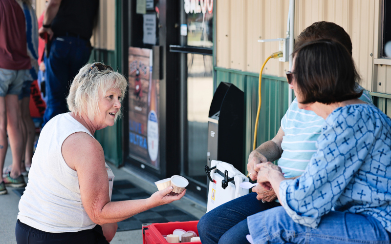 DeVonne Losing hands out free ice cream, donated by the Alpena Community Foundation, to help attendees beat the heat.