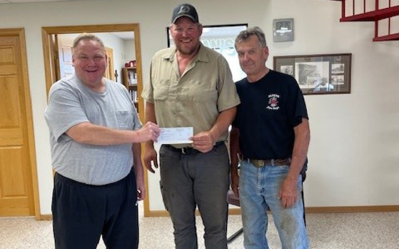 Check presentation to the Alpena Fire Department’s Volunteer Fireman Chris Albrecht, center, receiving the check, (over $2700) with Volunteer Fireman Bruce Orth, right and Todd Boomer, left. (COURTESY PHOTO)