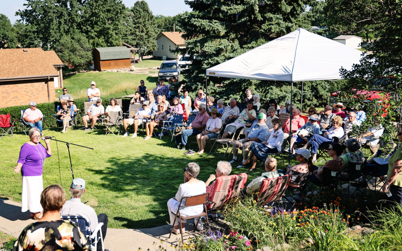 Susan Dean Arnott speaks to the crowd gathered on the lawn south of the Anne Hathaway Cottage