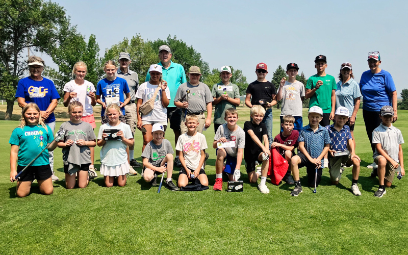 Young golfers gather at Springs Country Club during the July Youth Golf Clinic organized by Gloria Vavra and Becky Thompson. The summer program gave participants an opportunity to build their golf skills while learning course etiquette and sportsmanship.