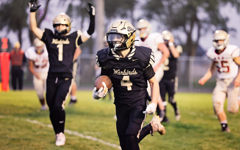Cayson Walters crosses the goal line for a Wolsey-Wessington touchdown as teammate Cooper Timm raises both arms to signal the score during the Warbirds’ 56-6 homecoming victory over Sunshine Bible Academy.
