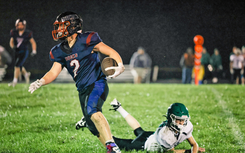 Wesley Molnar evades a tackle as he makes his way down the field for the Bucks. Molnar rushed for 70 yards and four touchdowns in the homecoming victory.