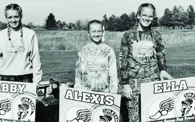 TOP: Pictured at the state cross-country meet in Huron are, left to right: Coach Becky Krueger, Alexis Roesler, Abby Kolousek and Ella Kolousek. ABOVE: Full of Spartan pride at state are Abby Kolousek, Alexis Roesler and Ella Kolousek.