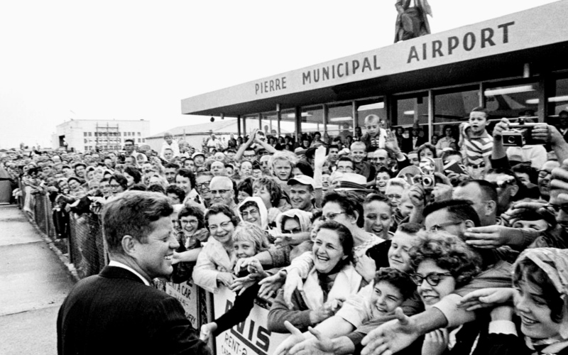 PHOTO COURTESY OF THE JOHN F. KENNEDY PRESIDENTIAL LIBRARY AND MUSEUM, BOSTON President John F. Kennedy, visiting South Dakota to dedicate the recently completed Oahe Dam, greets crowds at the Pierre Municipal Airport on Aug. 17, 1962.