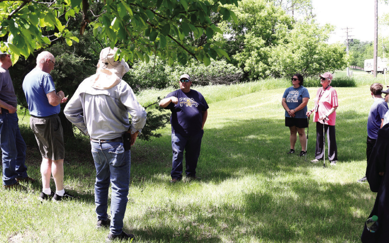 Wessington Springs High School Vo-Ag instructor Brady Duxbury points out identifying characteristics of trees during “A Walk in the Park” on May 31 in Wessington Springs City Park.