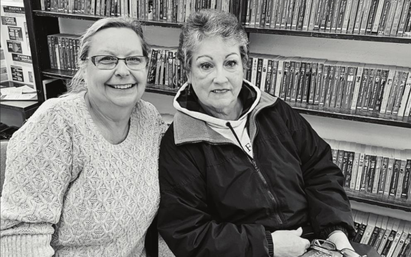 TOP PHOTO: Carnegie Library in Wessington Springs begins new hours through the noon hour on Fridays. RIGHT PHOTO: Librarian Rhonda Behrens (left) is shown with Val Channel, former board president of the library board who recently retired from board service.