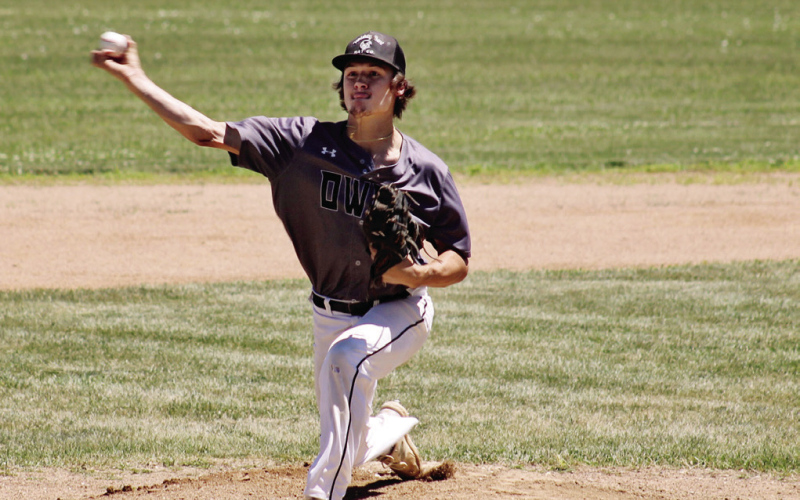 TOP: Dylan Schimke bats with Brock Krueger at third base during Sunday’s doubleheader against Chamberlain. Schimke drove in five runs across the two games as the Owls swept the Mallards. ABOVE: Springs Owl pitcher Bubba Peterson delivers a pitch during a first game doubleheader in Springs on Sunday. Despite 96 degree temperatures, Peterson pitched a six-inning 12-1 victory over the Chamberlain Mallards, striking out ten batters. (PHOTOS BY CRAIG WENZEL FOR THE TRUE DAKOTAN)