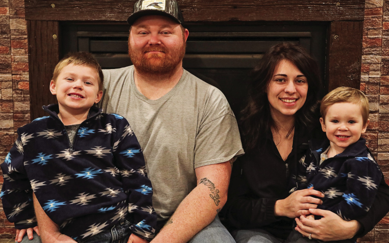 Adam Wolfcale and Summer Schooler are shown with their sons Zayden (left) and Brayzen Monday night at Dale and Sandy Wolfcale’s home, where they are staying after being displaced by a house fire on November 12.