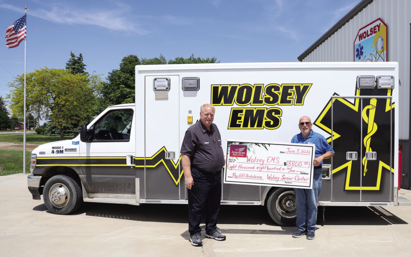 Wolsey Senior Citizen Center Incorporated board member Dave Burnison, right, presents an $8,800 check to Wolsey EMS Director Scott Spiehs at the Wolsey Fire Hall. The donation retired the remaining balance on the community’s ambulance, helping pay off approximately $170,000 in debt in just two years through community fundraising efforts, donations and grants. (KRISTI HINE/TRUE DAKOTAN)