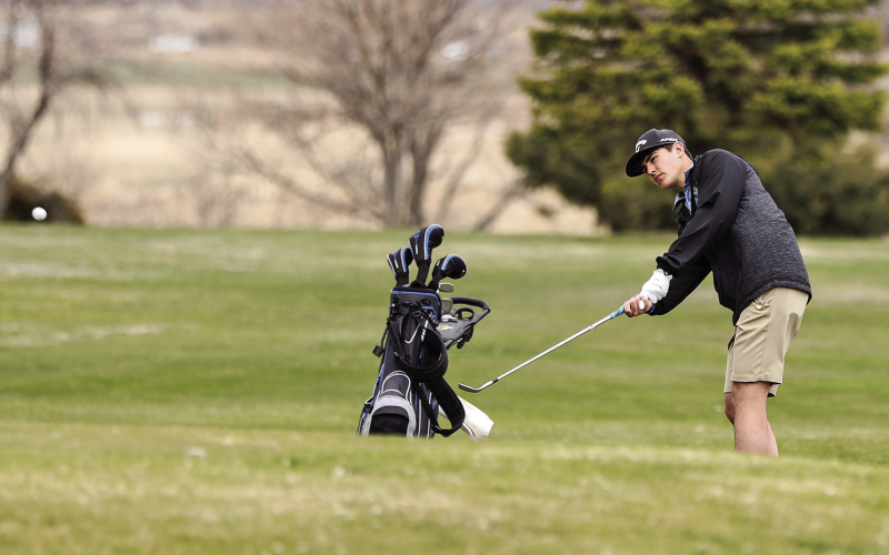 The Spartans hosted a golf invitational at Springs Country Club last week. Blake Miller, a member of the boys varsity team, chips the ball on the hole 9 green.