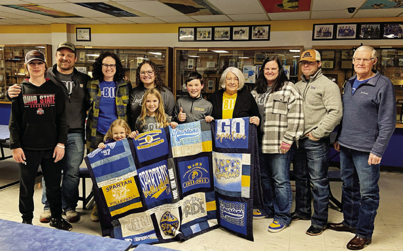 Pictured at center with Houston Havlik, Braun and the Bergeleen family are shown with the Spartan quilt donated by Donna Grieve that served as a focal point for Braun’s project. PHOTO COURTESY JILL BRAUN