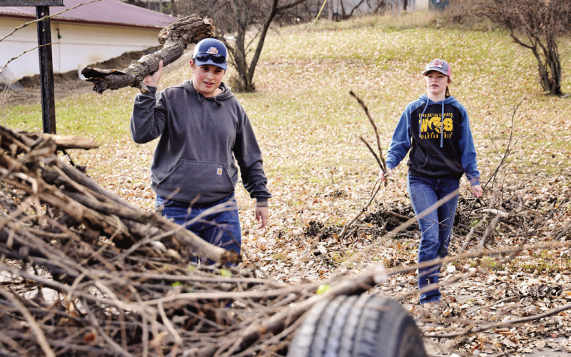 JR Hine and Madilyn Gaikowski haul branches.