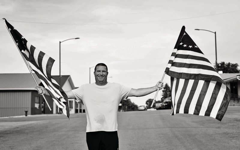 Marcus Damm stands on Main Street in Wessington Springs holding two of the 24 Betsy Ross-style American flags he purchased and installed along downtown light poles ahead of the Fourth of July holiday. Inspired by a conversation with his wife, Lynn, he organized the patriotic display, creating a festive welcome for residents and visitors during the holiday weekend.
