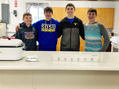 VFW baseball players Wesley Molnar, Blake Miller, Brock Krueger and Brett Miller helped serve the crowd at a recent VFW teener baseball benefit. DELIA ATKINSON / TRUE DAKOTAN