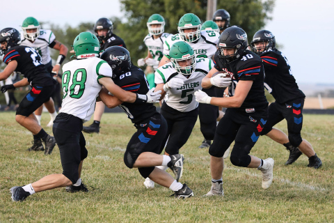 Carter Gaikowski (60) creates a path for Camden Jost to carry the ball down the field. Jost ran for 79 yards in the game. 