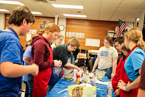 WSHS Family and Consumer Sciences/Technology Skills teacher Charlotte Mohling teaches eighth graders the basics of pie making with help from senior Riley Roduner. 