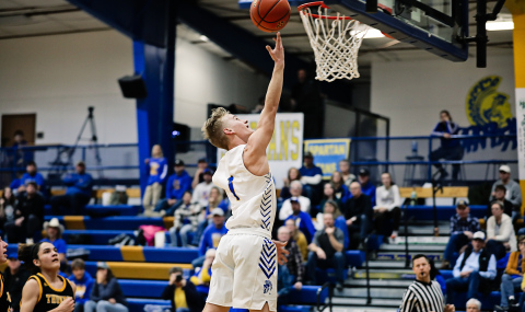 KRISTI HINE / TRUE DAKOTAN Blake Larson at the net during home basketball action vs. AC/ DC.