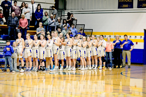 The Girls Spartans Basketball Team stands at attention during the National Anthem before the final regular season game of the year won at home against James Valley Christian by a score of 54-43. 