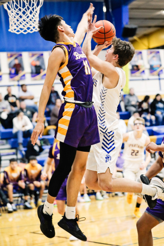 Ryder Michalek soars up to the net during home basketball action against Lower Brule. 