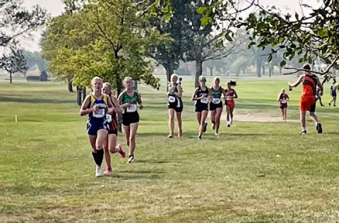 Freshman, Ella Kolousek (pictured at the front of the pack above)  finished the race in 27:45.34.
