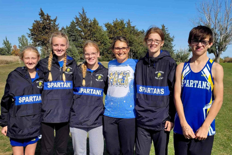 Shown with Coach Becky Krueger (center) are Spartans Cross Country state qualifiers Alexis Roesler, Abby Kolousek, Ella Kolousek, Masynn Mebius and Ranick Fjerstad.