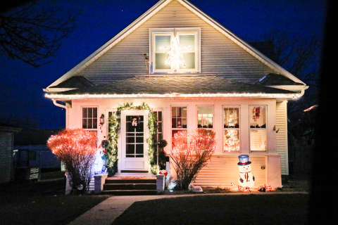 The Marcus and Lynn Damm house welcomes holiday visitors with a bright cheery entry.