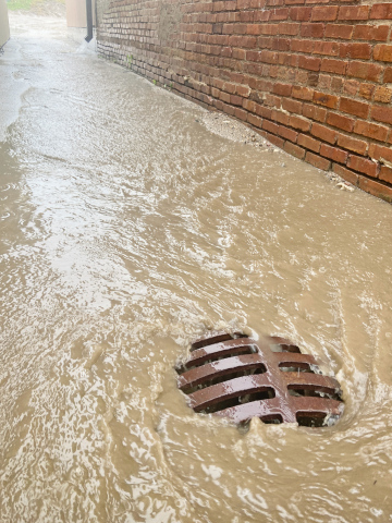 Water rushed down the alley between the True Dakotan and Springs Area Bus buildings last week during a storm that brought over four inches of rain to the area. KRISTI HINE / TRUE DAKOTAN