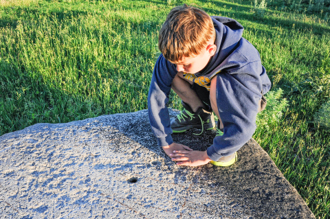 Boulders with chiseled holes are a mystery in northeastern South Dakota. Pondering the “holey rocks” of Roberts County is among the outdoor adventures South Dakota Magazine suggests with late summer in mind. PHOTO COURTESY SOUTH DAKOTA MAGAZINE