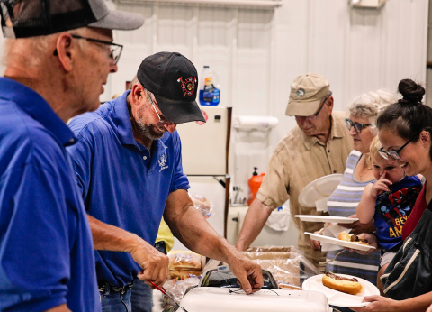 Wessington Springs Volunteer Firemen Mike Mebius and Jerry Van Den Oever laugh with community members as they serve a long line of attendees at the 2024 Firemen’s FunFest. 