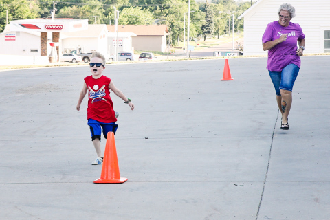 Axle Kurth and can’t contain his excitement during the kid fun run at the fire hall. He is shown with one of the event organizers Lori Van Den Oever. 