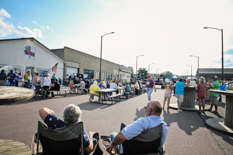 A large crowd gathered on Main Street in front of Pin Twisters following the Sons of American Legion Poker Run for a community supper and live musical entertainment Saturday. 