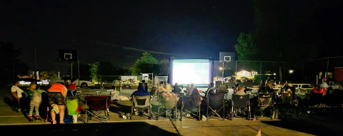 PHOTO COURTESY LOREE GAIKOWSKI The tennis courts in the city park were transformed into an outdoor movie theater Friday at dark.