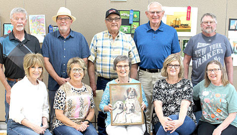 Cousins shown front row, left to right: Del Lomhein, Barb Murphy, Linda Roth holding one of Fred Mohling’s paintings, Karla Moody and Joan Swanson. Back row: Mike Lomheim, John Swanson, Kieth Mohling, Bill Roth and Karl Swanson.