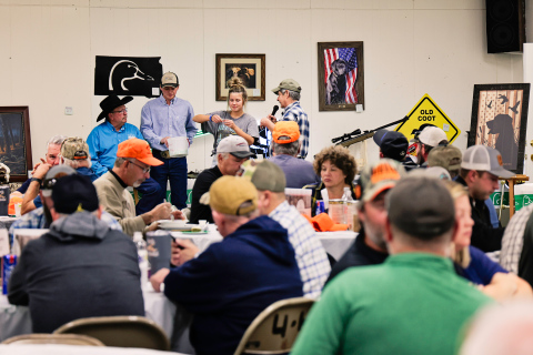 Auctioneers Val Luckett and Clayton Keck get a hand from Jada Kolousek and emcee Tom Mebius during the live auction held at the Ducks Unlimited Banquet Saturday. 
