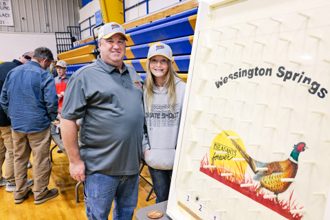 Aaron Roesler with daughter Lily are shown with one of the many games featured at the banquet. The event also boasted a wide variety of raffles and a live auction. 