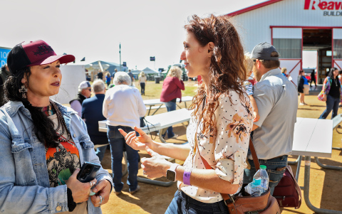 Rebecca Blue (right) networks with Christina Christensen on Aug. 22, 2024, at Dakotafest in Mitchell, S.D. Christensen owns Kimball Livestock Exchange and Christensen Charolais Ranch. KRISTI HINE/ SOUTH DAKOTA NEWS WATCH 