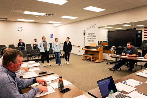 Wessington Springs FFA Floriculture team members Anna Arhart, Mercedes Jones and Mariah Messmer present information about their upcoming trip to the national convention to the school board Monday evening.