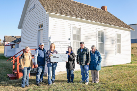 KRISTI HINE / TRUE DAKOTAN Pictured west of the Fagerhaug school house, left to right are: Tara Miller, Manager of Communications, Central Electric Cooperative; Merl Bechen, Operation Round-Up Trustee; Amber Kolousek, Operation Round-Up Trustee; Jean Ferguson, Darell Deneke and Sue Perry, all Dunham Historical Society volunteers.