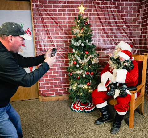 Jolly Old St. Nick made his annual stop during Santa Saturday on December 21, 2024. Pictured at City Hall in Wessington Springs is Michial Brodkorb of Wessington Springs, snapping a quick photo of his grandson Tyson Johnson, who was less than thrilled to meet Santa for the first time.